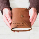 Leather journal with the quote "where words fail, music speaks" engraved on bottom lefthand corner