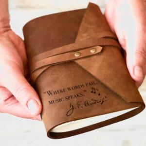 Leather Wrap around journal with the quote "where words fail, music speaks" engraved on bottom lefthand corner